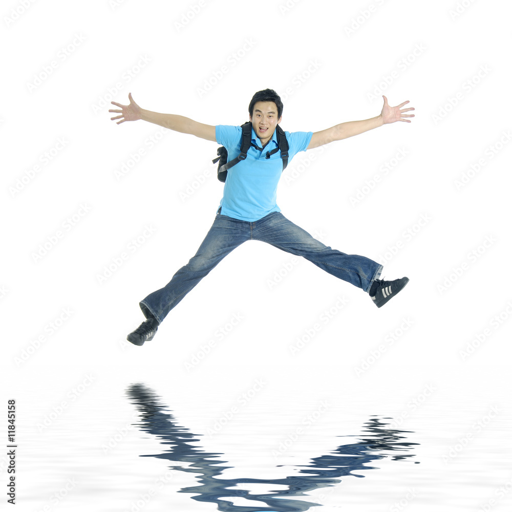 Reflection for excited young man jumping in mid-air cheering Reflection for excited young man jumping in mid-air cheering