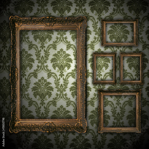 vintage grunge wall bacground with empty gold paiting frame