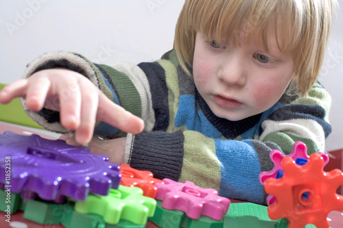 young child learning with some colourful cogs