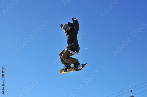 girl snowboarder on a high jump