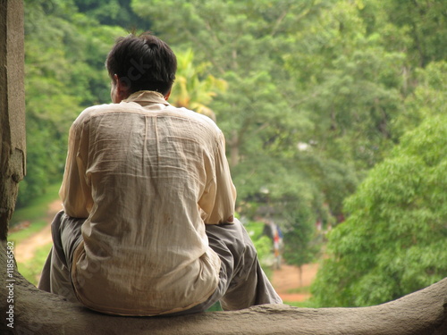 Homme assis dans Angkor Vat