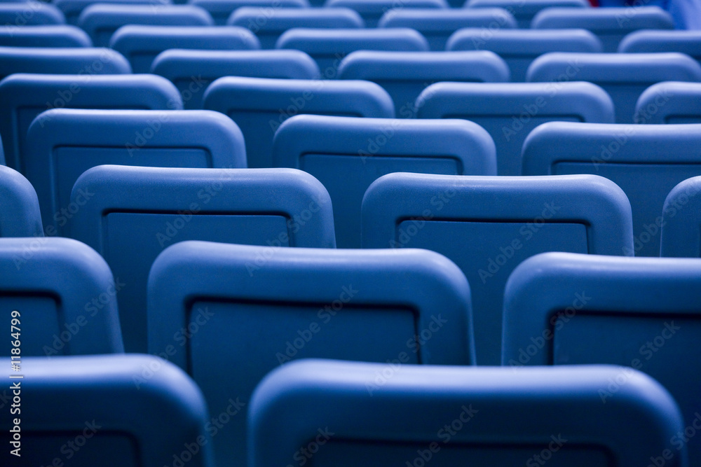 Fototapeta premium Rows of chairs in a lecture hall form a pattern.