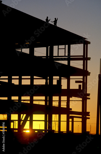 silhouette workers at construction site