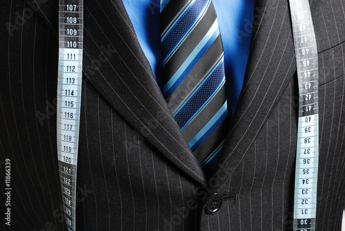 Business man with tape measure