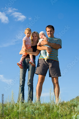 Happy family against the sky