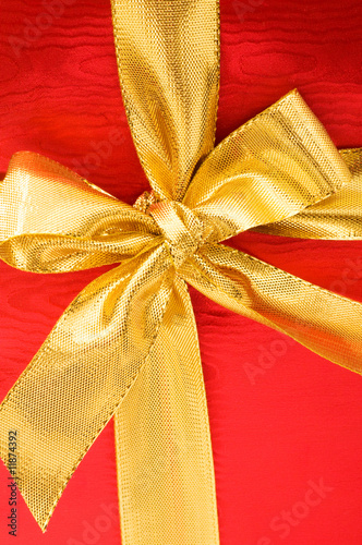 Close up of red gift box with gold bow