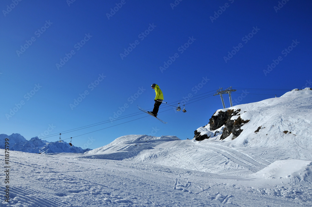 Aerial skiing: skier in yellow jacket