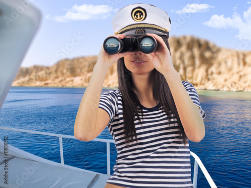 Young woman standing on the yacht is looking through © ZoomTeam
