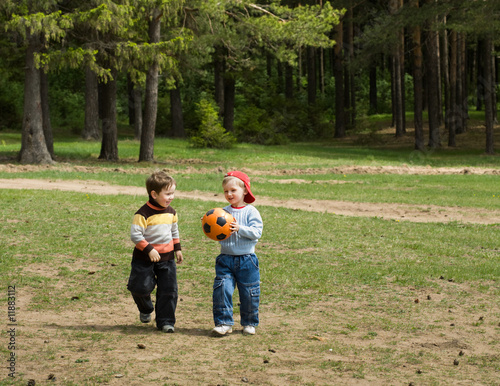 Two playful kids with ball
