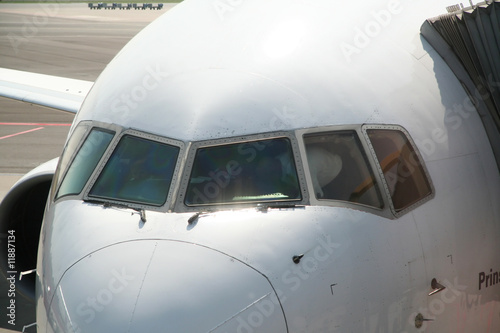 Cockpit of airplane at gate while pilots prepare departure