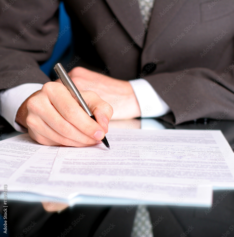 businessman writing on a form businessman writing on a form