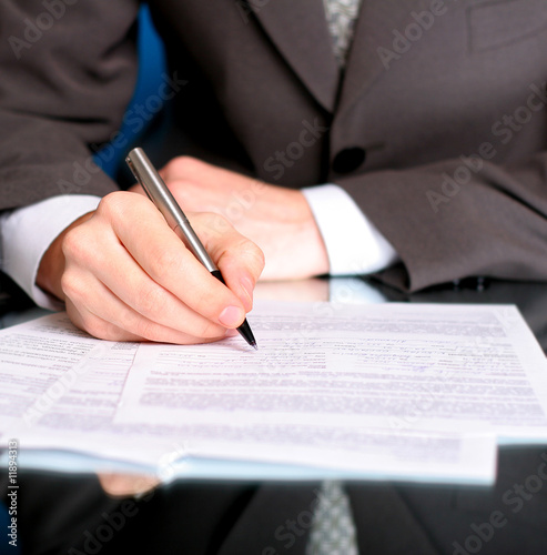 businessman writing on a form