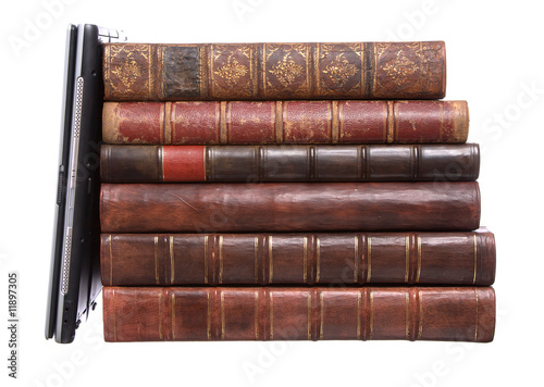 Old leather bound books with a laptop photo