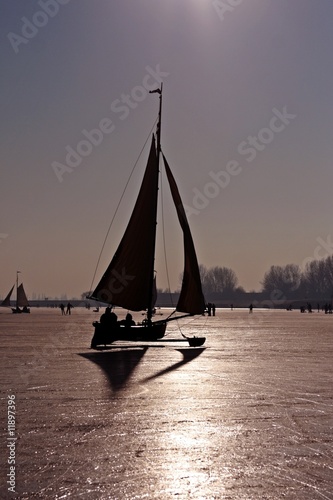 Ice sailing on a cold winterday in the Netherlands photo