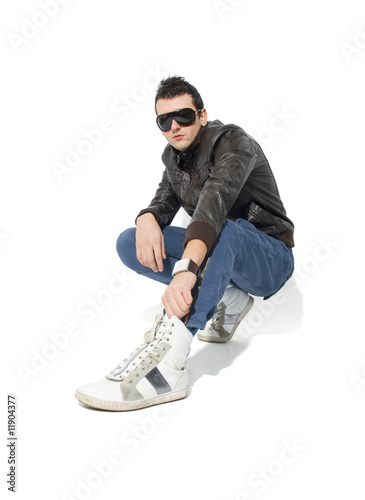 фотографія young trendy man wearing leather jacket and sunglasses