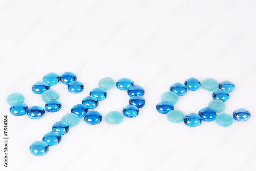 The word spa written and created in blue and turquoise glass stones on white background. Copy space. The word spa written and created in blue and turquoise glass stones on white background. Copy space.