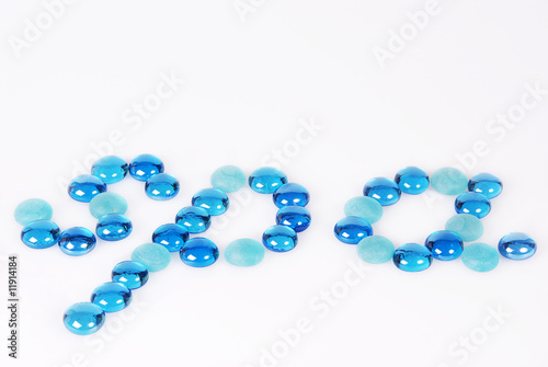 The word spa written and created in blue and turquoise glass stones on white background. Copy space.