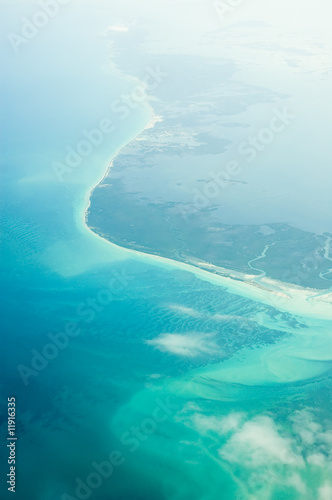 an aerial view of the ocean and clouds