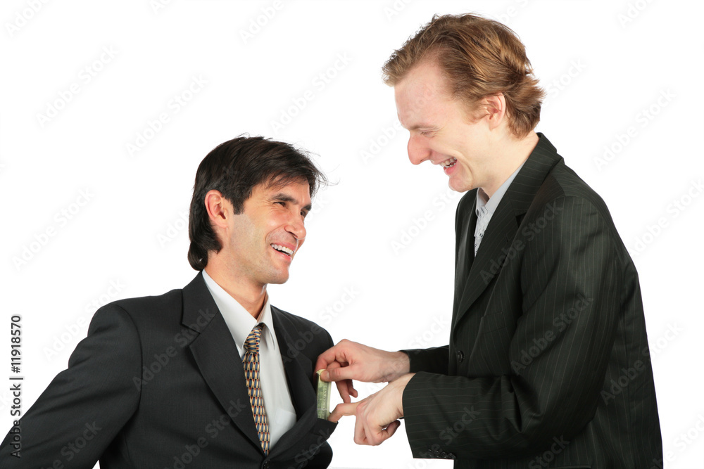One businessman places to another of money into pocket One businessman places to another of money into pocket