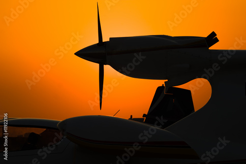 silhouette of airplane engine on sunset photo