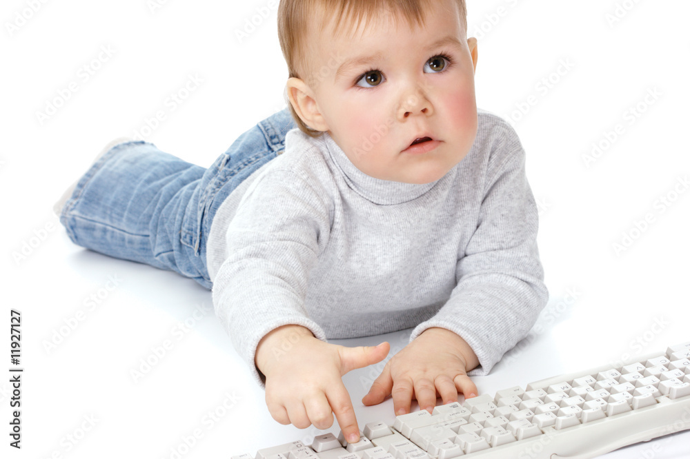Cute child typing on a keyboard Cute child typing on a keyboard