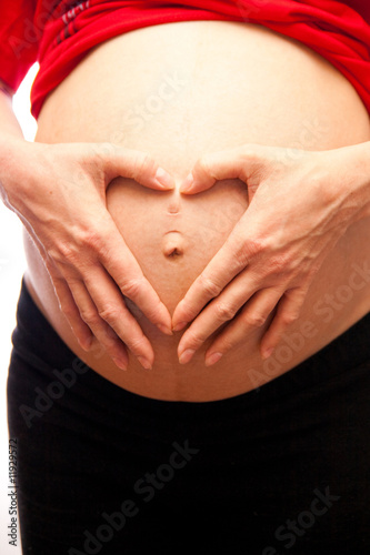Wallpaper Mural pregnant woman with her hands forming a heart symbol for love Torontodigital.ca
