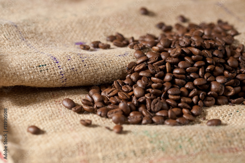 Close-up of roasted coffee beans on burlap Close-up of roasted coffee beans on burlap