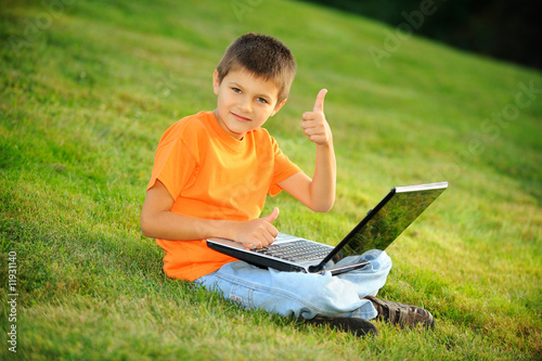 Happy young boy with laptop