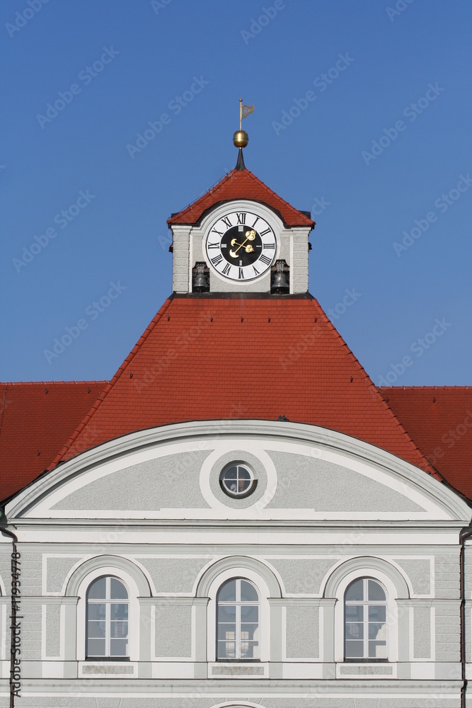 Fototapeta premium Detail of a castle. Red tiled roof with clock tower.