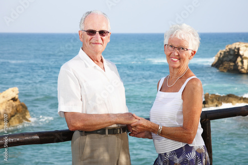 happy elderly couple holding hands