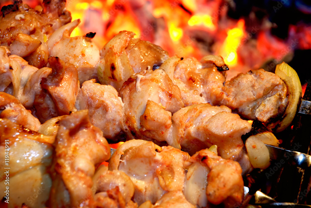 Closeup of preparation a shish kebab on fire