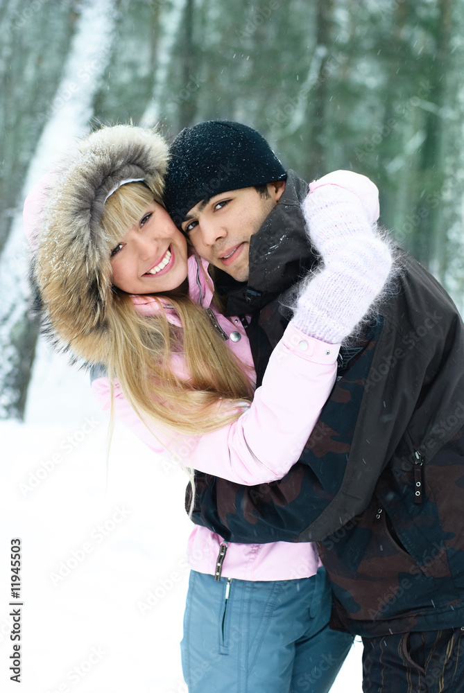 happy young couple in winter park