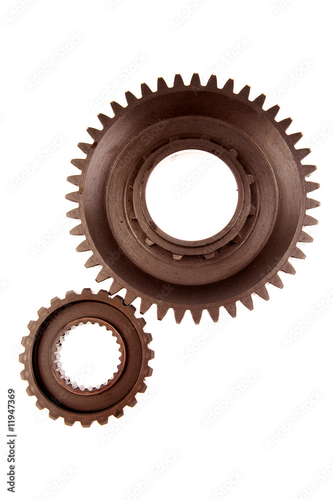 Two gears meshing together over white Two gears meshing together over white