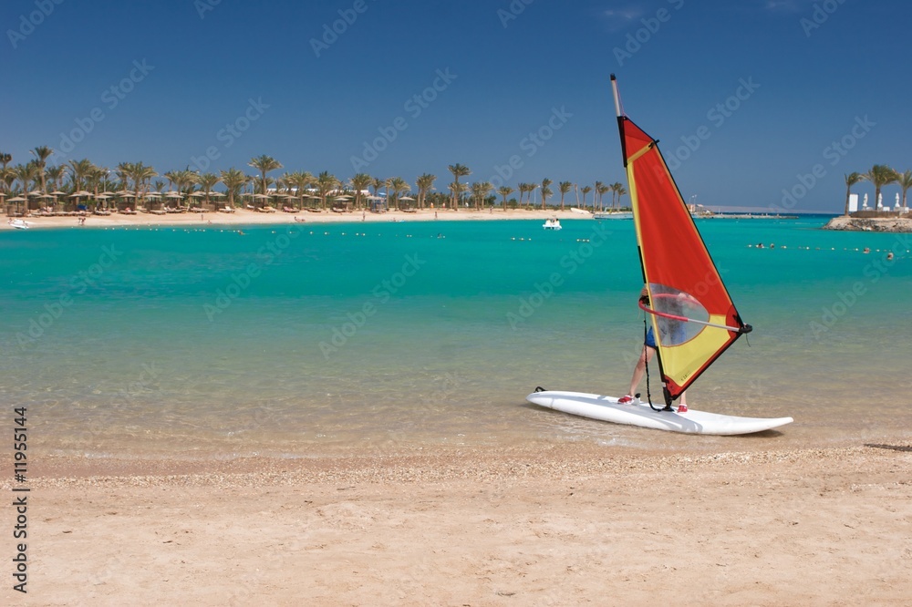 Fototapeta premium sunny beach and windsurfing board