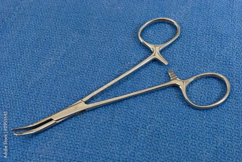 Hemostats on blue sterile field