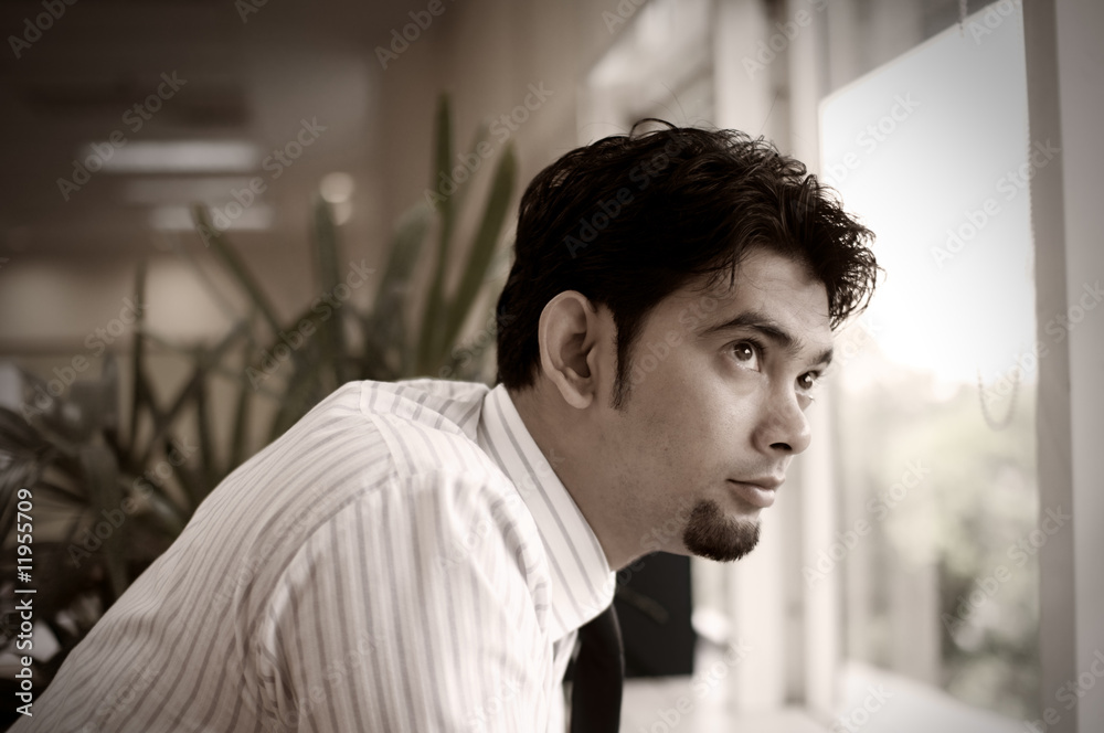 Obraz premium Corporate man looking out of windows