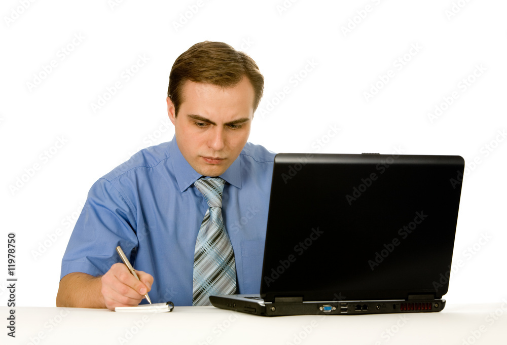 Young businessman working on a laptop. Isolated on white. Young businessman working on a laptop. Isolated on white.