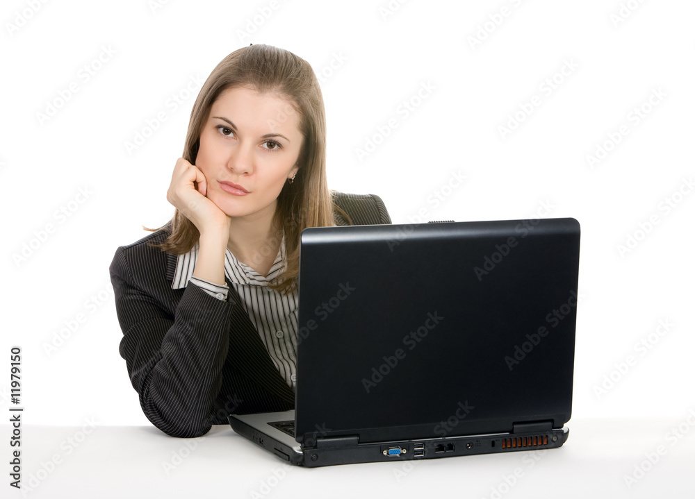 Beautiful young businesswoman working on a laptop. Isolated on w Beautiful young businesswoman working on a laptop. Isolated on w