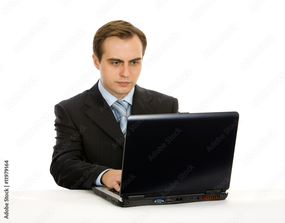 Young businessman working on a laptop. Isolated on white. Young businessman working on a laptop. Isolated on white.