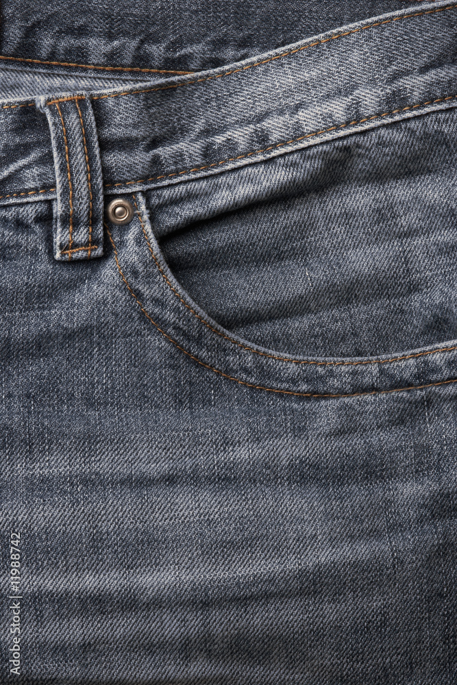 detail of a front pocket in a blue jeans pants detail of a front pocket in a blue jeans pants