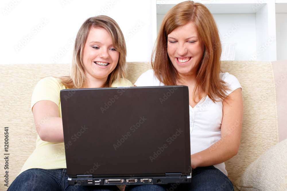 Cute girls sitting with laptop