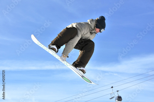Aeroski: girl snowboarder on a high jump