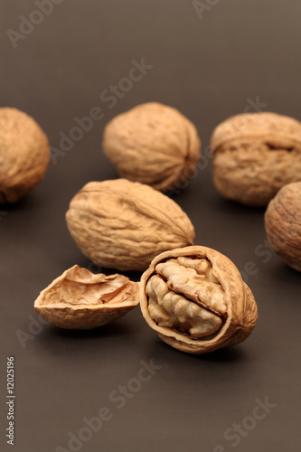 Cracked walnut with nutshell on background with walnuts