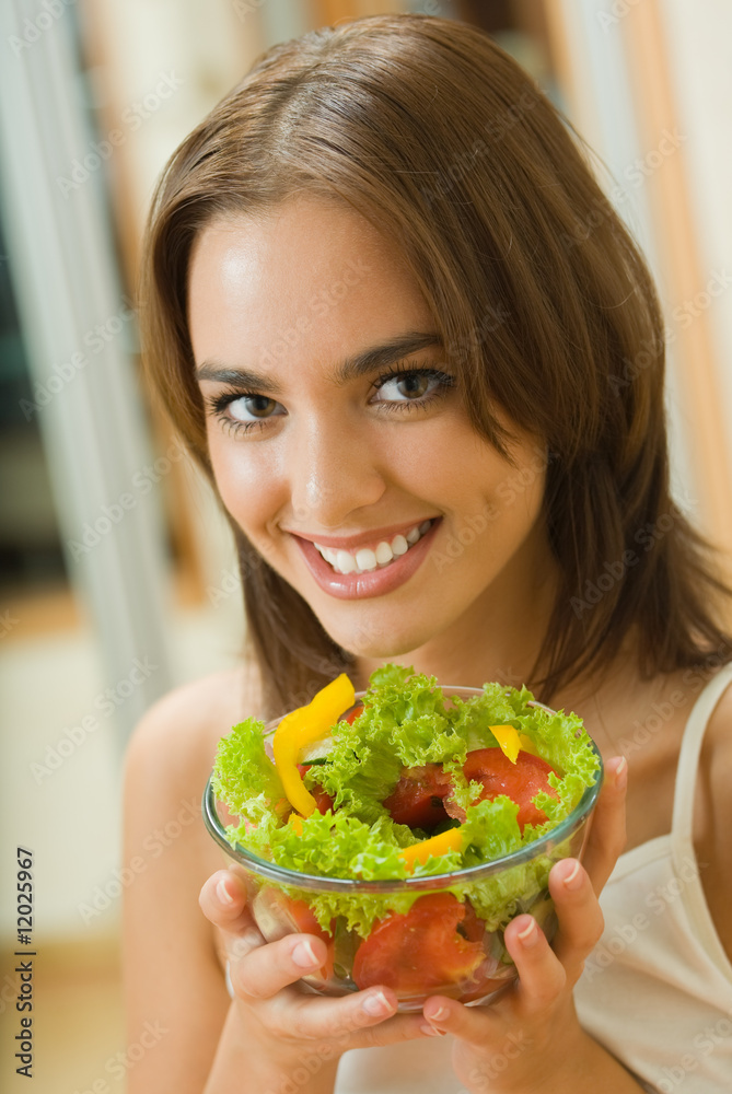 Portrait of young woman with salad at home Portrait of young woman with salad at home