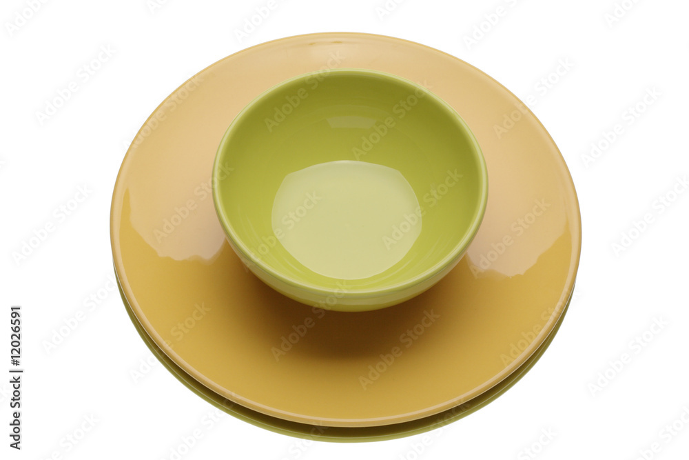 Yellow plate with green cup on white background Yellow plate with green cup on white background
