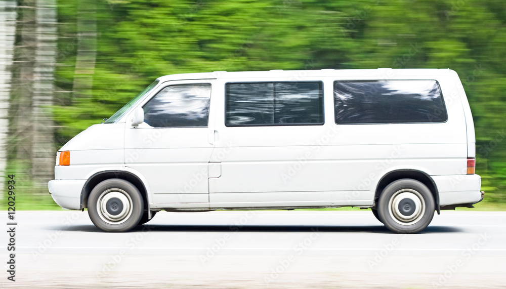 white van driving a country road