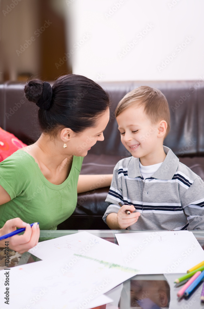 mother and a 5-year old son painting on paper mother and a 5-year old son painting on paper