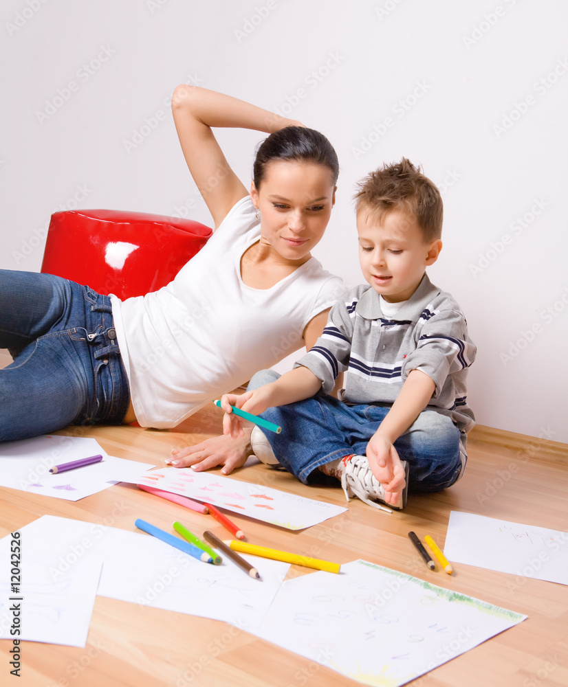 mother and a 5-year old son painting on paper mother and a 5-year old son painting on paper