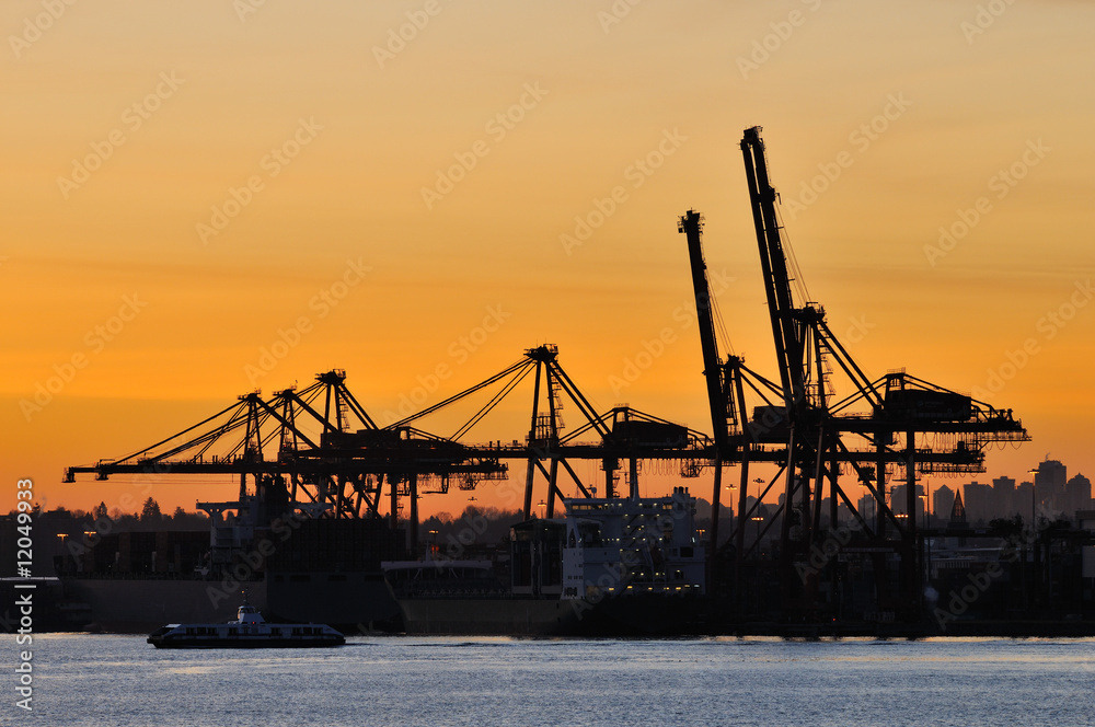 Industrial shipping crane at sunrise