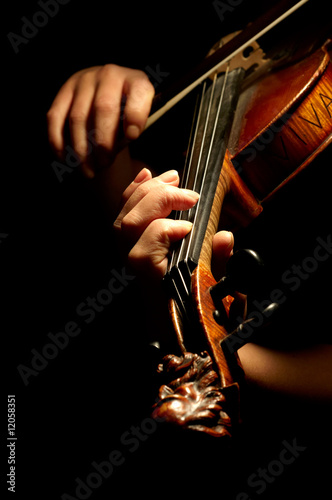 Musician playing violin isolated on black